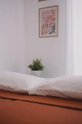 a close up of a bed with a plant on it at Casetta in Rome