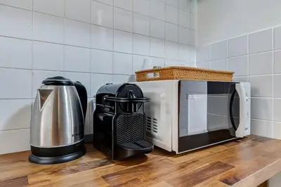 a coffee maker and a microwave on a kitchen counter at Vivilo Collection - Macelli Spanish Steps Apartment in Rome