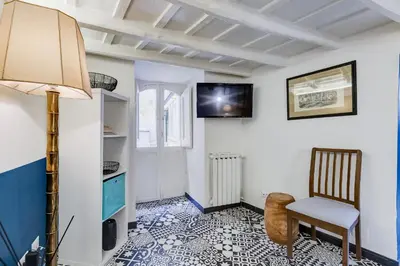 a living room with a lamp and a chair at Vivilo Collection - Macelli Spanish Steps Apartment in Rome