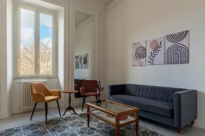 a living room with a blue couch and chairs at Dante's View - Pretty Homes in Rome