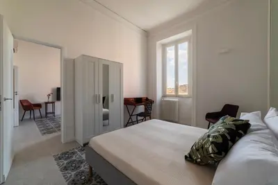 a bedroom with a bed and a room with a desk at Dante's View - Pretty Homes in Rome