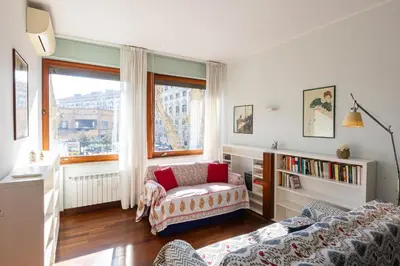 a living room with a couch and a book shelf at Amazing Apartment Trastevere in Rome