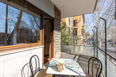 a table and chairs on a balcony with a window at Amazing Apartment Trastevere in Rome