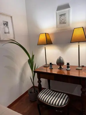 a room with a desk with two lamps and a chair at Casa Romantica in Rome