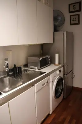 a kitchen with a washing machine and a microwave at Casa Romantica in Rome