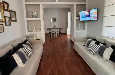 a living room with a couch and a television at Casa Romantica in Rome