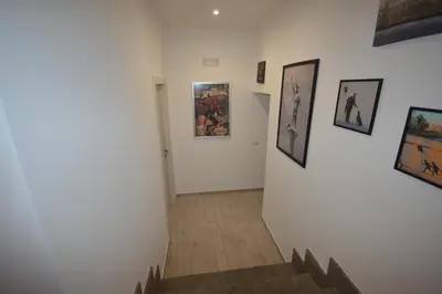 a hallway with pictures on the walls of a museum at San Remo Apartment in Rome