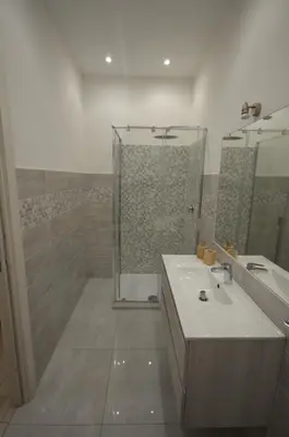 a bathroom with a sink and a shower at San Remo Apartment in Rome
