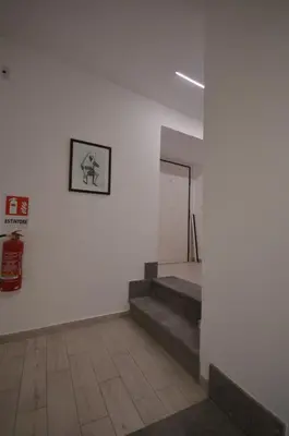 a hallway with stairs and a picture on a wall at San Remo Apartment in Rome