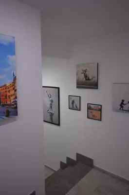 a group of pictures on a wall in a museum at San Remo Apartment in Rome