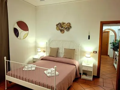 a bedroom with a bed with a pink bedspread at Candia 66 at the Vatican Museums in Rome