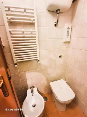 a small bathroom with a toilet and a sink at Candia 66 at the Vatican Museums in Rome