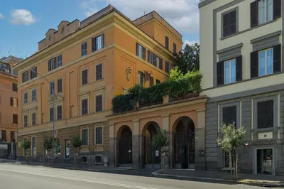 a yellow building on the side of a street at Salotto19 - Villa Borghese in Rome