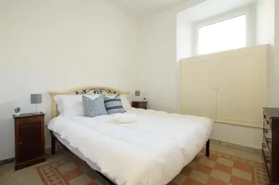 a large white bed in a room with a window at Salotto19 - Villa Borghese in Rome