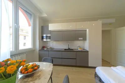 a kitchen with a table with a bowl of oranges on it at Palumbo 12 Holiday Home in Rome