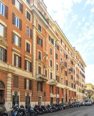 a large building with motorcycles parked in front of it at Palumbo 12 Holiday Home in Rome