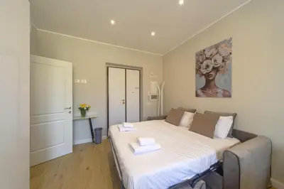 a bedroom with a bed with two towels on it at Palumbo 12 Holiday Home in Rome