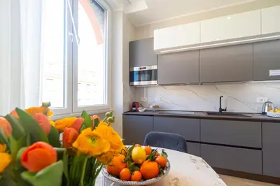 a kitchen with a table with a bowl of oranges at Palumbo 12 Holiday Home in Rome