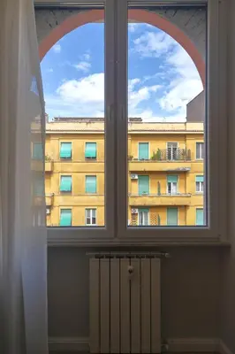 a window with a view of a building at Palumbo 12 Holiday Home in Rome