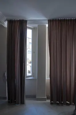 a room with two curtains and a window at Sistina Apartment in Rome