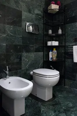 a bathroom with a white toilet and a sink at Sistina Apartment in Rome