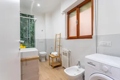 a white bathroom with a sink and a toilet at Domus Citro, Cozy Flat in District Prenestina in Rome