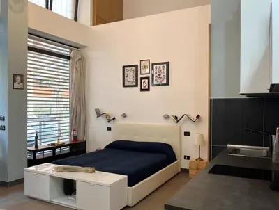 a bedroom with a bed and a sink at Loft Lumineux à Trastevere in Rome