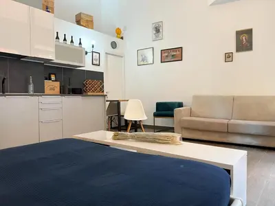 a living room with a couch and a table at Loft Lumineux à Trastevere in Rome