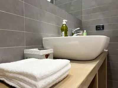 a bathroom with a sink and a counter with towels at Loft Lumineux à Trastevere in Rome