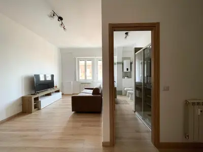 a living room with a couch and a mirror at Numa House in Rome