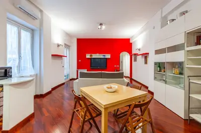a kitchen and dining room with a table and chairs at Vacanze Romane con giardino in Rome