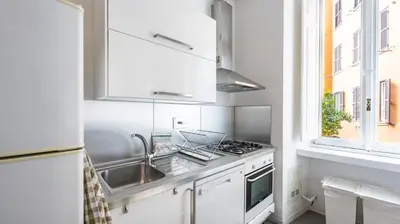 a white kitchen with a sink and a stove at Casa Maria Teresa by Rentbeat in Rome