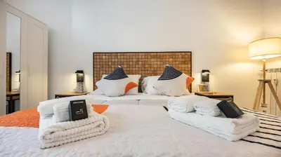 a bedroom with two beds with white sheets and pillows at Casa Maria Teresa by Rentbeat in Rome