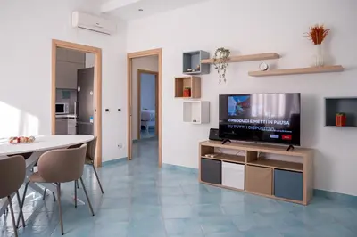 a living room with a television and a table and chairs at Domus Blu Aurelia in Rome