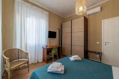 a living room with a couch and a painting on the wall at GuestHost - San Giovanni Laterano Apartment in Rome