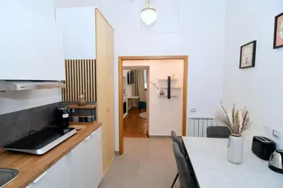 a kitchen with a counter top and a table at Elegant Suite Colosseo in Rome