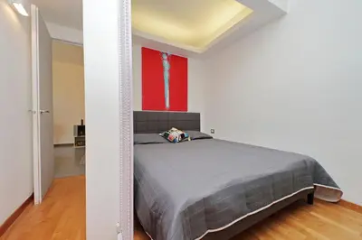 a bedroom with a bed and a red wall at Manzoni in Rome