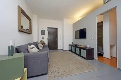 a living room with a couch and a television at Manzoni in Rome