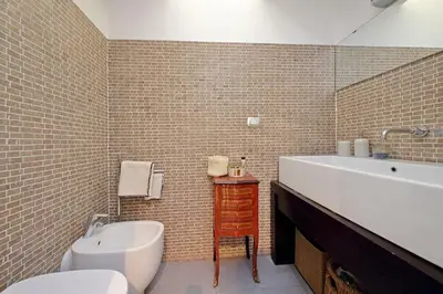 a bathroom with a tub and a sink and a toilet at Manzoni in Rome