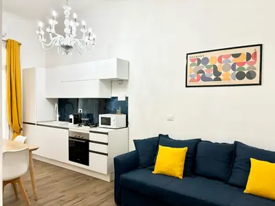 a living room with a blue couch and a kitchen at RomeAsYouLike-Esquilino Apartment N 86 in Rome