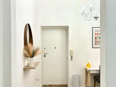 a hallway with a white door with a vase on it at RomeAsYouLike-Esquilino Apartment N 86 in Rome