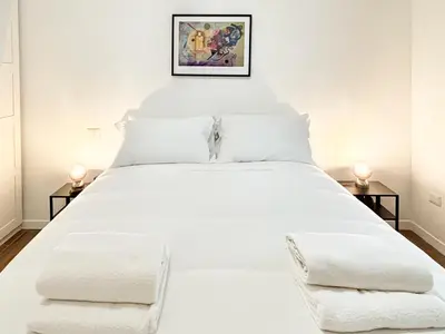 a bedroom with a white bed with two side tables at RomeAsYouLike-Esquilino Apartment N 86 in Rome