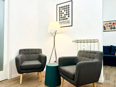 two chairs and a lamp in a living room at RomeAsYouLike-Esquilino Apartment N 86 in Rome
