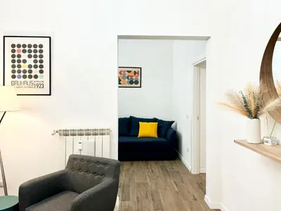 a living room with a blue couch and a chair at RomeAsYouLike-Esquilino Apartment N 86 in Rome