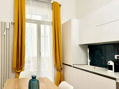 a kitchen with a table and a yellow curtain at RomeAsYouLike-Esquilino Apartment N 86 in Rome