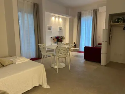 a room with a table and chairs and a bed at Trecento7Flat in Rome
