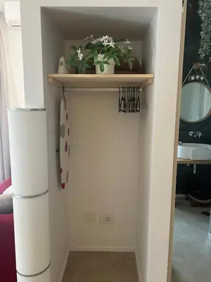 a door in a room with a shelf and plants at Trecento7Flat in Rome