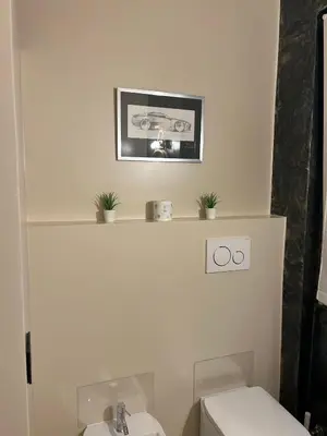 a bathroom with a toilet and a picture on the wall at Trecento7Flat in Rome