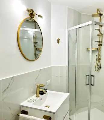 a bathroom with a sink and a mirror at La Piccola Luxury Suite in Rome