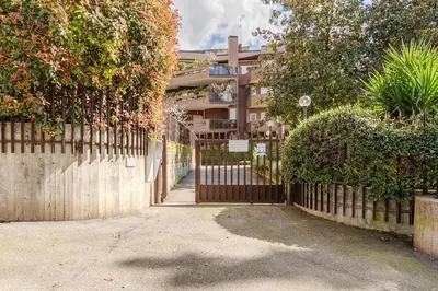 a fence with a gate in front of a building at La Piccola Luxury Suite in Rome